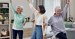 Dancing, senior women and caregiver with wellness, music and freedom with happiness, stress relief and .retirement Female people, home or happy group with movement, energy and health in a living room