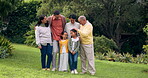 Family, grandparents and children outdoor at a park with love and care. Senior man and woman with young parents and happy kids together in a garden for quality time, bonding and fun holiday adventure