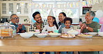 Family, birthday and singing at table for celebration with kid or senior people in home . Children, cake and parents with grandfather at party with hats or snacks in kitchen for special event.