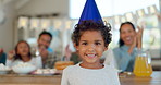 Happy, face and kid with birthday party, celebration and excited family in applause for boy in home, house or living room. Portrait of child, celebrating and people together for special event