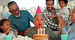 Birthday party, applause and a senior woman with her family at home together in celebration of a life milestone event. Kids, parents and grandparents with cake in a house to celebrate their grandma