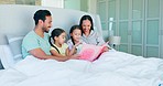 Family, reading book and children learning in bedroom, study or knowledge. Kids, mother and father storytelling in bed in the morning, education or bond together with happy parents teaching in home