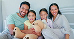 Bed, happy family and portrait of parents with love for children and playing with teddy bear toy together in a bedroom. Care, mother and father with kids in room for support, morning and security