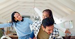 Happy, flying and a family being playful in a house, bonding and game together in the living room. Laughing, portrait and a child and parents playing for love, comedy and care in the lounge for fun