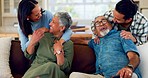 Hug, happy and people with their senior parents relaxing, bonding and talking in the living room. Happiness, smile and adult children embracing a elderly man and woman in retirement on a sofa at home