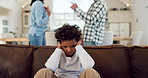 Divorce, fear and a boy with parents fighting in the home during marriage problems, conflict or domestic violence. Stress, anxiety or trauma with a male child scared at mom and dad shouting in anger