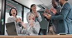 Clapping, success and business people on computer of project bonus, financial goals or profit celebration in office. Finance group, men and women high five and applause, yes or winner news on laptop