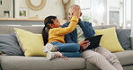 Tablet, high five and a man with his daughter on a sofa in the home living room for education or gaming. Kids, success and support with a man motivating his gamer girl child while sitting together