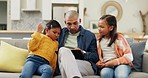 Father watching a video with his children on a tablet on a sofa in the living room at home. Bonding, love and young dad browsing on social media or the internet with girl kids on digital technology.