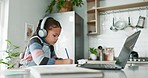 Online class, laptop and child with headphones in kitchen, learning and education with home school. Elearning, studying and writing exam, girl with homework in house for virtual classroom project.