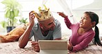 Tablet, games and father with girl child on a bed with love, bond and fun while playing with a crown in their home. Online, e learning and kid with parent in bedroom for streaming, movies or playing