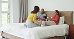 Happy, family and children on bed for conversation in home with bonding for care. Kid, together and parents with talking in bedroom for quality time or to relax with communication with laughing.