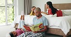 Father, reading book and girl in bedroom together for quality time with family or learning storytelling, language and development. Dad, mom and children in room bonding with love, care and support