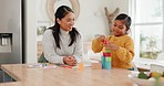 Happy, building blocks and mom with her girl kid in the kitchen for child development at home. Smile, bonding and young Asian mother helping her daughter with wood toys for fun at their house.