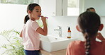 Siblings, home or children in bathroom brushing teeth together in daily morning or grooming routine. Kids, oral care or girls cleaning teeth together with toothbrush or toothpaste for dental health