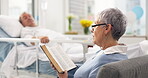 Healthcare, an old woman reading the bible to her husband during a visit and a couple in the hospital. Medical, retirement or religion with a senior wife and man patient at a clinic for faith in god