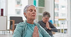 Senior people, yoga class and coach meditation, prayer and peace hands for exercise, holistic wellness and mindfulness. Spiritual workout, group and calm elderly women, clients and personal trainer