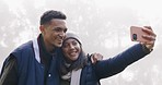 Selfie, nature and couple on an outdoor camp for a romantic weekend trip together in winter. Happy, smile and young man and woman taking a picture in misty or fog forest while on holiday or adventure