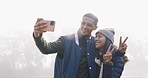Selfie, happy and couple on an outdoor camp for a romantic weekend trip together in winter. Happy, smile and young man and woman taking a picture with peace sign in fog forest on holiday or adventure