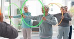 Senior workout, hula hoop and people with coach for fitness, wellness and training together. Happy, gym and elderly group of friends with trainer and gear for exercise in nursing home for retirement