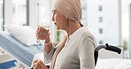 Cancer, Parkinson and elderly woman at hospital in wheelchair with water after chemotherapy or treatment. Health, elderly care and female patient with disability, sickness or disease and depression