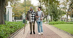 Help, cane and nurse with old woman in park for relax, support and person with a disability. Elderly care, conversation and healthcare with caregiver and patient in nature for medical rehabilitation