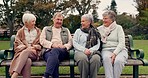 Conversation, bonding and senior friends in a park sitting on bench for fresh air together. Happy, smile and group of elderly people in retirement in discussion or talking in an outdoor green garden.