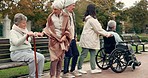 Friends, walking and elderly people in park for bonding, wellness and quality time together outdoor. Friendship, health and senior man and women with caregiver in nature for fresh air, calm and relax