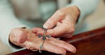 Rosary, praying or hands of woman in church for God, holy spirit or religion with faith in Christian cathedral. Jewelry closeup, spiritual lady or person in chapel or sanctuary to praise Jesus Christ