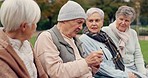 Conversation, laughing and elderly friends in a park sitting on bench for fresh air together. Happy, smile and group of senior people in retirement in discussion or talking in an outdoor green garden