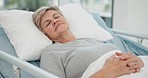 Hospital, sleep and senior woman in bed for recovery, resting and relaxing after surgery treatment. Healthcare, clinic and elderly female person with eyes closed for medical care, service and help