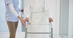 Nurse, senior woman and walker for helping hand, show support and guide in rehabilitation at clinic. Caregiver, elderly person with disability and mobility frame with empathy, physiotherapy and care