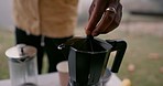 Hands, boiling coffee and kettle for camping, filter or press for water, smoke or steam with closeup in woods. Zoom, outdoor kitchen or drink for energy, matcha or espresso to start morning in forest