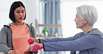 Dumbbells, physical therapy and a senior patient with a woman and tablet for rehabilitation. Elderly person with physiotherapist for muscle exercise, workout or physio progress assessment with tech