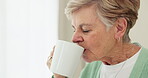 Senior woman, coffee and thinking by window at home to remember memory and relax in retirement. Face of an elderly person or old lady at nursing facility with hope, drinking tea and Alzheimer disease