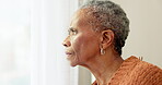 Senior woman, face and thinking by window at home to remember memory and relax in retirement. Serious black elderly person or old lady at nursing facility with hope, sad emotion and Alzheimer disease