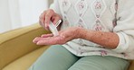 Sick, medicine and hands of person on the sofa for routine medical supplement in a house. Closeup, daily and a woman with pills, tablet or vitamin c for healthcare on the living room couch of a home