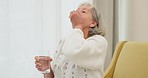 Water, pills and senior woman on a sofa with medicine for health, balance and aging wellness in her home. Tablet, swallow and elderly lady in living room with vitamin c, collagen or iron and calcium