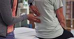 Hands, back pain or physiotherapy for senior patient with help in physical therapy rehabilitation. Patient closeup, chiropractor or physiotherapist massaging spine or muscle injury for body healing