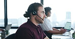 Call center, customer service and a man talking on headset in a coworking office for crm or advice. Male consultant for contact us, technical support and help desk or sales agent for telemarketing