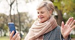 Nature, video call and senior woman in a park talking on her phone while on a walk for fresh air. Communication, technology and elderly female person in retirement in a virtual conversation in garden