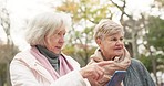 Senior, women and friends with phone in a forest for location, search or guide while walking. Smartphone, directions and old people in park online for map, tracking or gps travel assistance in nature