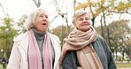 Senior, friends and women in a park bond, walking and enjoying conversation outdoor together. Elderly, ladies and happy, walk and talking in in a forest on weekend, relax and having fun in nature