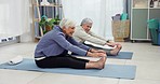 Senior, women and fitness stretching in a living room for exercise, workout and wellness at home. Elderly, friends and ladies on a yoga mat in a living room for training, health and body stretch