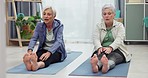 Stretching, body and senior women fitness in living room for exercise, workout and wellness at home. Elderly, friends and ladies on a yoga mat on lounge floor for training, health and leg stretch