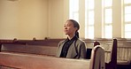 Religion, holy and young woman in church for service for spiritual health and christian prayer. Praise, peace and female person sitting on wood bench for Sunday worship sermon in chapel congregation.