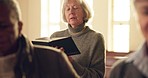 Senior woman, church and singing with worship, praise and hymn book in faith, religion or reading. Elderly Christian lady, focus and holy song in sermon, respect or harmony with spiritual mindfulness