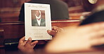 Death, memory and person in church for a funeral, service program or paper programme with face of senior man on a pamphlet. Mourning, grief and person with empathy and support for family in chapel 
