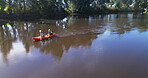 People in boat for exercise, sports and lake, kayak in nature with camping activity outdoor and support. Woods, river and adventure, fitness and active in summer, teamwork and freedom while rowing