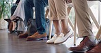 Feet, business group and job interview with nervous worker in waiting room and office. Excited, shoes and row of anxiety of people sitting in a queue for recruitment and hiring opportunity in lobby